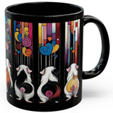 A black ceramic mug featuring a colorful artistic print of three guinea pigs seen from behind, set against a background of vertical multicolored stripes and hearts. – image 3