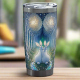 Enchanted Bunny Rabbit Love Trail Chrome Tumbler -- a stainless steel travel tumbler with a clear lid, featuring a detailed fantasy print of two white rabbits sitting together in a glowing blue and green forest with glowing orbs, shown on a wooden table with a blurred background. – image 3