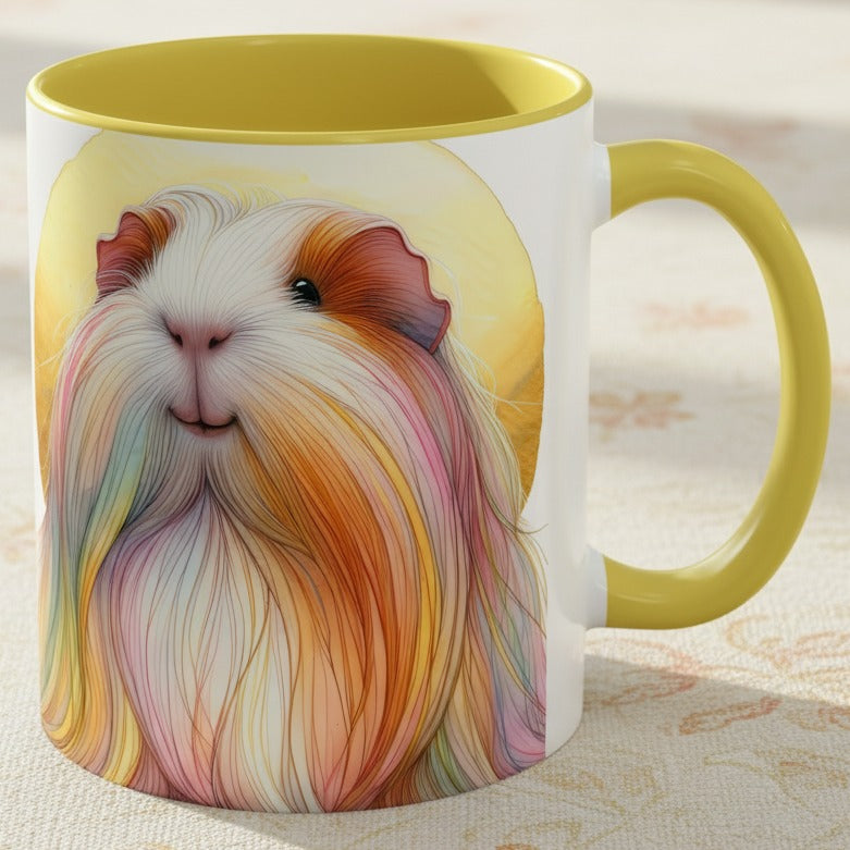 A white ceramic mug with a yellow interior and handle, featuring a colorful illustration of a long-haired guinea pig on the front, set on a light patterned fabric surface.