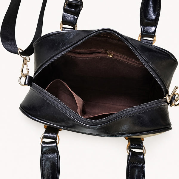 Open shoulder handbag interior showing two open pockets and one zippered pocket